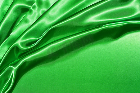 丝绸摄影照片_漂亮的折叠绿色丝绸背景