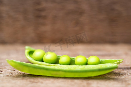 甜豌豆摄影照片_以乡村木质为背景的豆荚里的新鲜甜豌豆