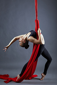 Aerial silk. Pretty young dancer posing at camera