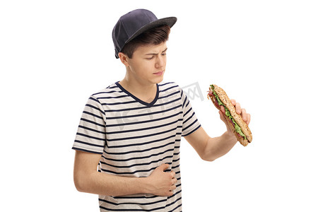 三明治摄影照片_青少年吃三明治和胃疼痛