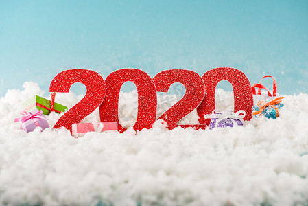 数字2020和白雪中的圣诞礼品盒 