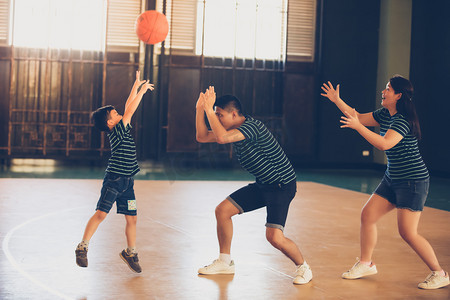孩子篮球摄影照片_亚洲家庭一起打篮球。家人在一起共度佳节快乐
