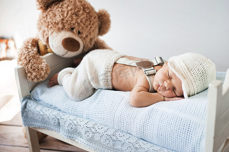 国家行动方案摄影照片_小宝宝睡着一只泰迪熊