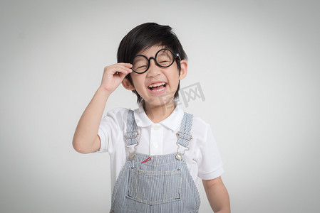 快乐亚洲儿童戴眼镜微笑灰色背景