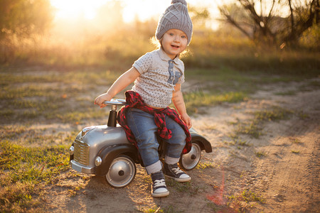 Toddler playing with toy car outdoors