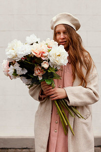 春天水果摄影照片_正面视图时尚的女人户外拿着花束鲜花春天