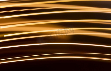 照明和背景概念-暗背景上的金色电光效果线条。暗背景上的金色电灯效果