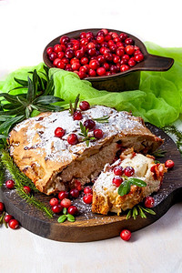 美味的蔓越莓派与新鲜蔓越莓和香草的圣诞木盘子。