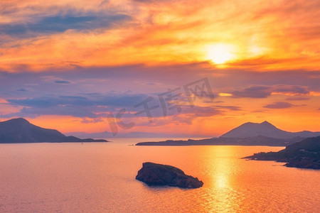 日落大海摄影照片_日落时分，可以看到爱琴海和希腊岛屿的景色。希腊索尼昂角。带岛屿的爱琴海日落景色