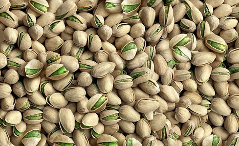 开心果种子背景是一大群自然开放的种子,代表健康的零食和营养丰富的