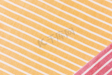 黄色格子背景摄影照片_红色织物黄色白色条纹织物桌布