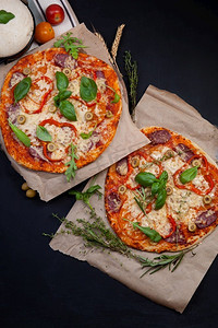 木板上蔬菜摄影照片_美味的新鲜披萨在黑暗中