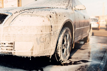 洗车玻璃摄影照片_湿车泡沫，汽车泡沫，洗车。洗车站