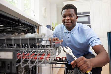 青年水管工培训在厨房安装家用洗碗机
