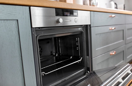 食品烹饪，烹饪和家用电器概念—厨房开放式烤箱。在家庭厨房打开烤箱
