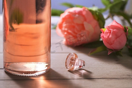 特写镜头瓶粉红玫瑰葡萄酒和春天的花朵