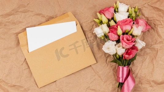 信封花卉摄影照片_俯瞰美丽的玫瑰花束和信封