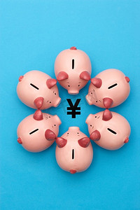 矢量粉色小猪摄影照片_印有日元标志的粉色存钱罐照片