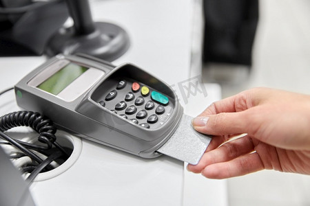 购物，支付和金融概念—近距离接触信用卡在读卡器。在读卡器中用信用卡近距离接触