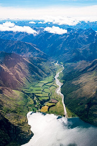 俯瞰山脉摄影照片_俯瞰山脉和湖泊景观。全景拍摄从飞机飞越附近的山脉在皇后镇，新西兰。