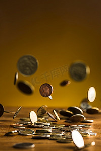 银和金币和下降的硬币在木桌子背景。银和金币和下降的硬币在木背景