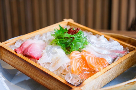 日本料理生鱼片三文鱼生鱼片沙拉在冰上供应的木托盘在日本料理餐厅 