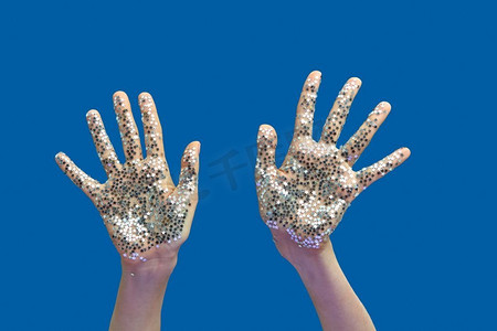 女人的手上有节日装饰,蓝色上闪闪发光的小星星.