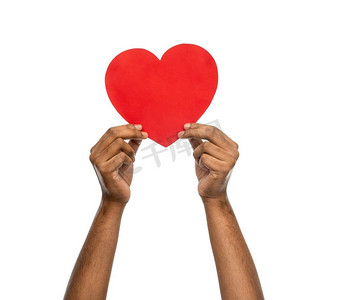 爱心帮助摄影照片_慈善、爱心、健康理念--手握红心白底合影。握住红心的手的特写