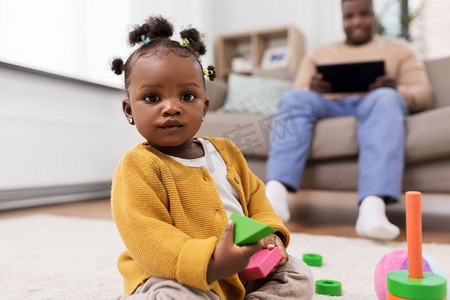 童年和人的概念-非洲裔美国小女孩在家里玩玩具积木。非洲女婴在家中玩积木玩具