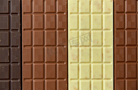 糖果，糖果和食物概念—牛奶，黑和白巧克力棒纹理背景。不同种类的巧克力在棕色背景