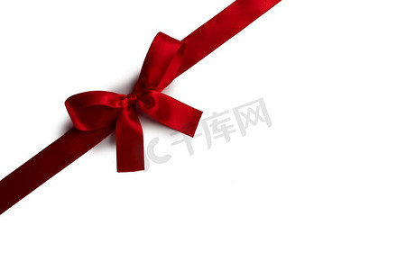 圣诞红摄影照片_在白色背景隔绝的红缎丝带弓。红色弓孤立在白色