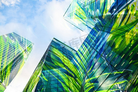 现代摩天大楼窗户和郁郁葱葱的绿色植被双重曝光—生态友好的绿色城市