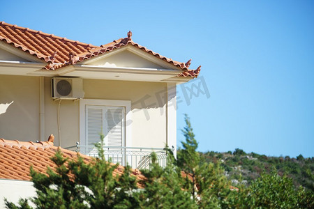 海滨文化旅游摄影照片_希腊，地中海式建筑。希腊海滨度假村的房子。米色的房子希腊海滨度假村的房屋