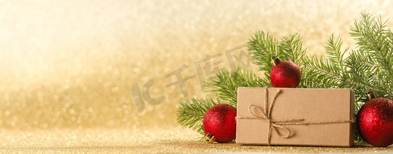圣诞或新年装饰品，工艺纸礼盒，金光闪闪的冷杉树枝背景，复制空间。圣诞礼物和装饰品
