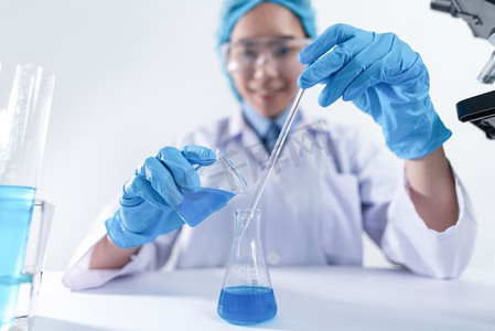 实验室中使用化学物质和显微镜进行研究的研究人员