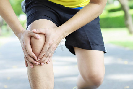 膝盖胀痛摄影照片_跑步者在体能测试中因意外事故引起严重膝盖疼痛。