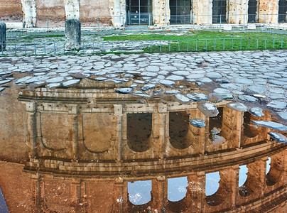 砖摄影照片_鹅卵石砖铺湿街道与斗兽场反射在罗马，意大利