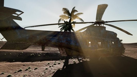 军事领域摄影照片_日落时分，一架破旧的军用直升机在沙漠中