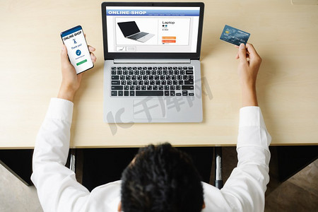 网购网摄影照片_年轻人使用信用卡在笔记本电脑应用程序或网站上进行在线购物支付。电子商务和网购的概念。