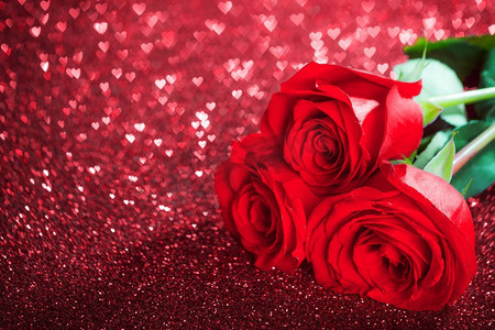 在闪光的心脏bokeh背景的红玫瑰花与复制空间情人节概念。红玫瑰花和闪闪发光的心
