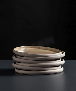 餐具、厨房用具和餐具概念--黑色餐桌上陶瓷盘的特写。黑色桌子上陶瓷板的特写