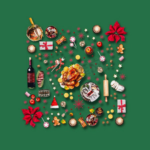 各种圣诞食品和圣诞晚餐的红色装饰。在绿色背景，顶视图组成图案