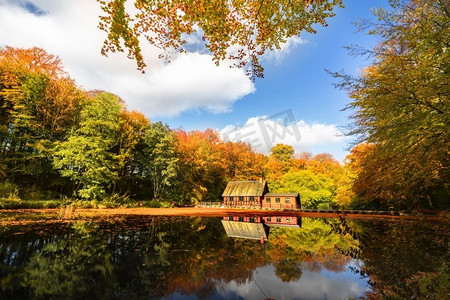 秋天森林湖边的小红房子，有着美丽的秋色