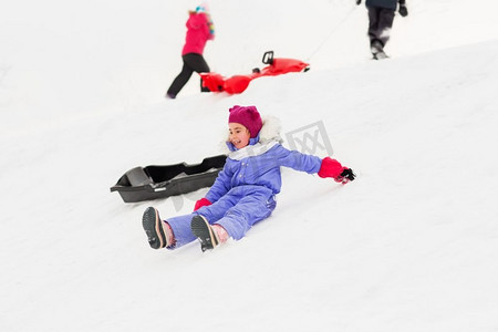 童年，雪橇和季节概念—一群快乐的小孩子在冬天的雪山雪橇。小孩子与雪橇在雪山在冬天