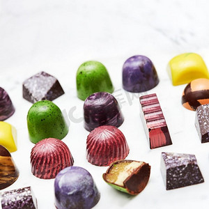 彩色的收集巧克力糖果孤立在白色大理石背景。一套各种手工糖果