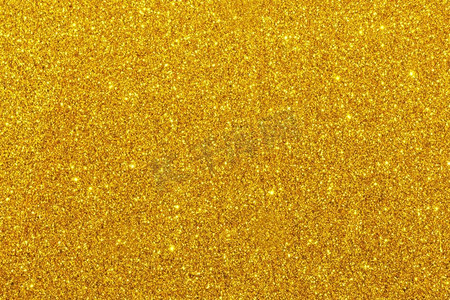 金黄色闪光图摄影照片_金色闪光闪闪发光的背景假日聚会设计。闪闪发光的背景