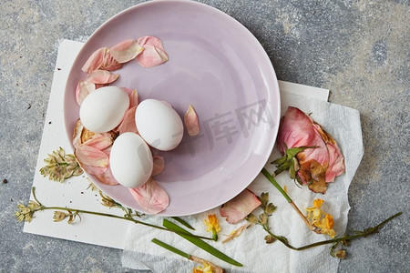复活节彩蛋的顶视图在粉彩的板代表。美丽的组成复活节假期海报。鸡蛋设计在背景