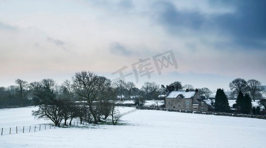 日出时分，美丽的白雪覆盖着山顶的冬景。风景画。英国山顶地区日出时分白雪覆盖的冬季景观