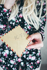金发女郎女人拿着复古纸信封 