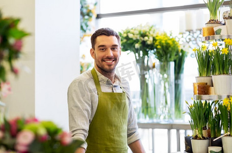 销售，小企业和花店概念—快乐的微笑花店人或卖家在花店。花店柜台的卖花人或卖花人